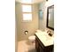 Bathroom featuring a dark wood vanity with white sink and a well-lit window at 1936 S Poplar St, Denver, CO 80224