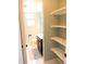 Bright bathroom with storage shelves near the toilet, a modern vanity, and tiled floors at 1936 S Poplar St, Denver, CO 80224