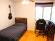 Comfortable bedroom with a single bed, desk, ceiling fan, and hardwood floors at 1936 S Poplar St, Denver, CO 80224