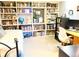 Inviting bedroom with built-in bookshelves and a comfortable bed and desk setup at 1936 S Poplar St, Denver, CO 80224
