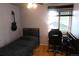 Cozy bedroom featuring a full bed and a desk next to a window offering natural light at 1936 S Poplar St, Denver, CO 80224
