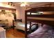 Bedroom boasts a bunk bed and closet with wooden floors and a ceiling fan at 1936 S Poplar St, Denver, CO 80224