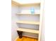 Well-organized closet with wooden shelves, offering ample storage space at 1936 S Poplar St, Denver, CO 80224