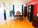 Bright dining room featuring hardwood floors, stylish lighting, and ample seating at 1936 S Poplar St, Denver, CO 80224
