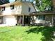 Charming two-story home with well-manicured lawn, brick accents, and attached garage at 1936 S Poplar St, Denver, CO 80224