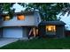 Two story home with attached garage, brick and siding, and an American flag in the front yard at 1936 S Poplar St, Denver, CO 80224