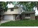 Well-maintained two-story house with a two-car garage and a lush green lawn at 1936 S Poplar St, Denver, CO 80224