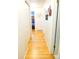 Hallway featuring hardwood floors and white walls, leading to various rooms in the home at 1936 S Poplar St, Denver, CO 80224