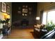 Comfortable living room with brick fireplace, hardwood flooring, and natural light at 1936 S Poplar St, Denver, CO 80224