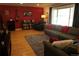Comfortable living room showcasing hardwood floors, a red accent wall, and ample natural light at 1936 S Poplar St, Denver, CO 80224