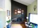 Cozy living room with a brick fireplace, high ceilings, and large windows allowing ample natural light at 1936 S Poplar St, Denver, CO 80224