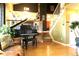 Open living room featuring a piano, staircase, and hardwood floors, offering a blend of elegance and comfort at 1936 S Poplar St, Denver, CO 80224