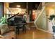 Inviting living room featuring a grand piano, hardwood floors, and staircase at 1936 S Poplar St, Denver, CO 80224
