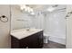 Updated bathroom with a large vanity, mirror, new fixtures, and tiled shower at 1820 Newland Ct # 210, Lakewood, CO 80214