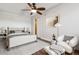 Cozy bedroom with wood-look ceiling fan, hardwood floors, and comfortable seating area at 1820 Newland Ct # 210, Lakewood, CO 80214