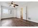 Spacious bedroom featuring wood floors, a ceiling fan, a window, and white walls at 1820 Newland Ct # 210, Lakewood, CO 80214
