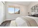 Bright bedroom with large window, neutral decor, and closet, offering a cozy and relaxing space at 1820 Newland Ct # 210, Lakewood, CO 80214