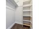 A well-organized closet with built-in shelving and a hanging rod provides ample storage space at 1820 Newland Ct # 210, Lakewood, CO 80214
