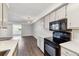 Open kitchen featuring stainless steel appliances, light gray cabinetry, and quartz countertops at 1820 Newland Ct # 210, Lakewood, CO 80214