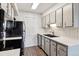 Updated kitchen with stainless steel appliances, white cabinets, and subway tile backsplash at 1820 Newland Ct # 210, Lakewood, CO 80214