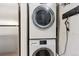 Efficient laundry area with stacked washer and dryer, perfect for compact living and convenience at 1820 Newland Ct # 210, Lakewood, CO 80214