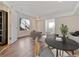 Open-concept living and dining area with stylish decor, wood floors, and lots of natural light at 1820 Newland Ct # 210, Lakewood, CO 80214