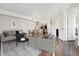 Bright living room with modern decor, stylish furnishings, and hardwood floors leading to dining area and kitchen at 1820 Newland Ct # 210, Lakewood, CO 80214