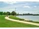 Scenic park view with paved path alongside the lake and green space, perfect for outdoor activities at 1820 Newland Ct # 210, Lakewood, CO 80214