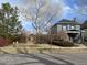 Charming house featuring a beautiful front yard with mature trees and lush greenery at 2238 Newton St, Denver, CO 80211