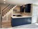 Contemporary kitchen featuring an island, stainless steel appliances, and a staircase at 2238 Newton St, Denver, CO 80211