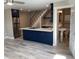 A modern kitchen with an island and stainless steel appliances opens to a small bath at 2238 Newton St, Denver, CO 80211