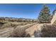 Walkway and lush landscaping create a serene outdoor space, perfect for relaxation and enjoyment at 7009 Winter Ridge Pl, Castle Pines, CO 80108