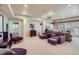 Finished basement with neutral walls, carpet, a projector, and ample seating space at 7009 Winter Ridge Pl, Castle Pines, CO 80108
