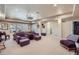 Finished basement boasts plush seating, a projector, and ample space for entertaining or relaxing at 7009 Winter Ridge Pl, Castle Pines, CO 80108