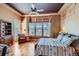Cozy bedroom with large windows, hardwood floors, and designer touches at 7009 Winter Ridge Pl, Castle Pines, CO 80108