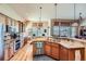 Well-lit kitchen with granite counters, stainless steel appliances, and beautiful wooden flooring at 7009 Winter Ridge Pl, Castle Pines, CO 80108