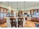 Charming kitchen with granite countertops, a breakfast bar, and stainless steel appliances at 7009 Winter Ridge Pl, Castle Pines, CO 80108