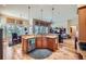 Modern kitchen seamlessly flows into the dining and living areas, creating an open-concept living space at 7009 Winter Ridge Pl, Castle Pines, CO 80108