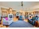 Cozy living room featuring a fireplace, hardwood floors, and an open floor plan at 7009 Winter Ridge Pl, Castle Pines, CO 80108
