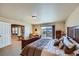 Spacious main bedroom with lots of natural light, carpet, and a sliding glass door to the outside at 7009 Winter Ridge Pl, Castle Pines, CO 80108