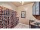 Custom wine cellar with extensive rack storage and countertop for wine enthusiasts at 7009 Winter Ridge Pl, Castle Pines, CO 80108