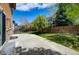 A backyard with stone accents, grassy lawn, and a concrete patio for entertaining and enjoyment at 25994 E Peakview Pl, Aurora, CO 80016