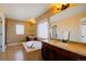 Bathroom featuring double sinks, a large mirror, and a soaking tub at 25994 E Peakview Pl, Aurora, CO 80016