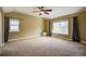 Primary bedroom with vaulted ceiling, ceiling fan, carpeting, and window at 25994 E Peakview Pl, Aurora, CO 80016