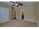 Bright bedroom with an open doorway to an ensuite bathroom and ample closet space at 25994 E Peakview Pl, Aurora, CO 80016