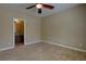Cozy bedroom with neutral tones, ceiling fan, and en-suite bathroom entrance at 25994 E Peakview Pl, Aurora, CO 80016