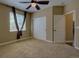 Comfortable bedroom with a ceiling fan, large window, and a spacious closet for ample storage at 25994 E Peakview Pl, Aurora, CO 80016