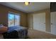 Bedroom with a large window and closet doors at 25994 E Peakview Pl, Aurora, CO 80016