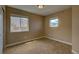 Well-lit bedroom featuring cozy carpet, neutral paint, and a pair of bright, double hung windows at 25994 E Peakview Pl, Aurora, CO 80016