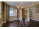 Formal dining area with hardwood floors, chandelier, and natural light streaming through large window at 25994 E Peakview Pl, Aurora, CO 80016